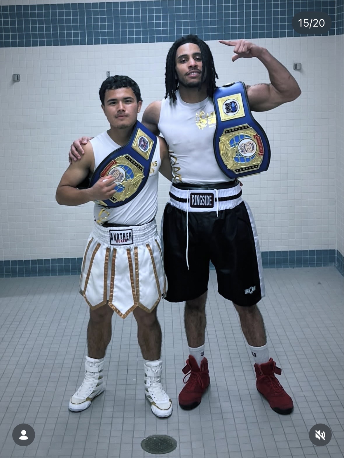 Two Lions Den fighters with championship belts